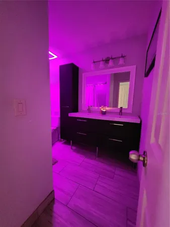 a bedroom with a bed and a ceiling fan