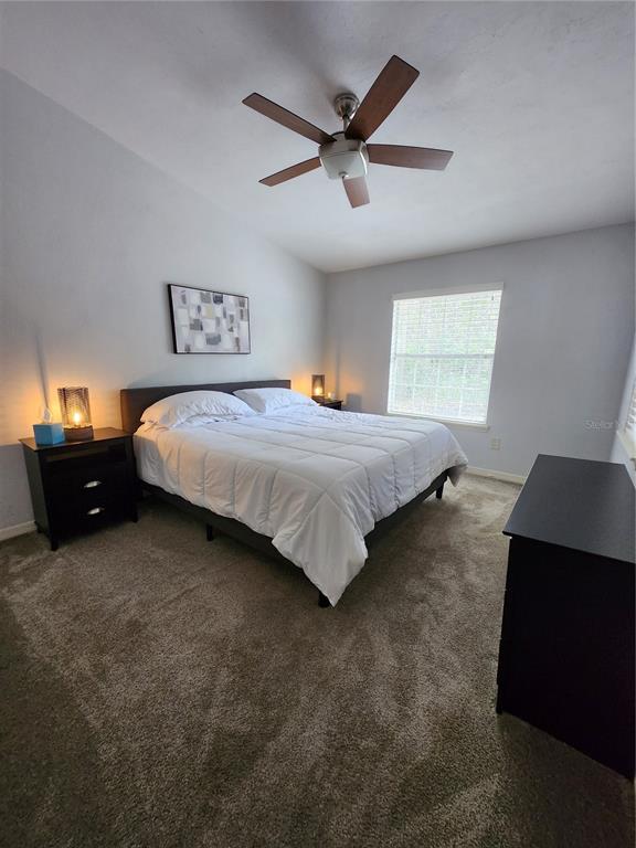 4801 Northwest 2nd Place Gainesville, FL 32607 - Photo 32 of 36 a bedroom with a bed and a ceiling fan