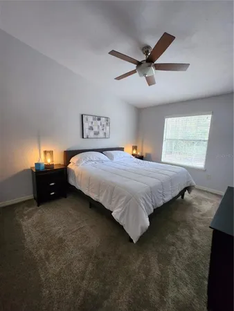 a living room with furniture a piano and wooden floor