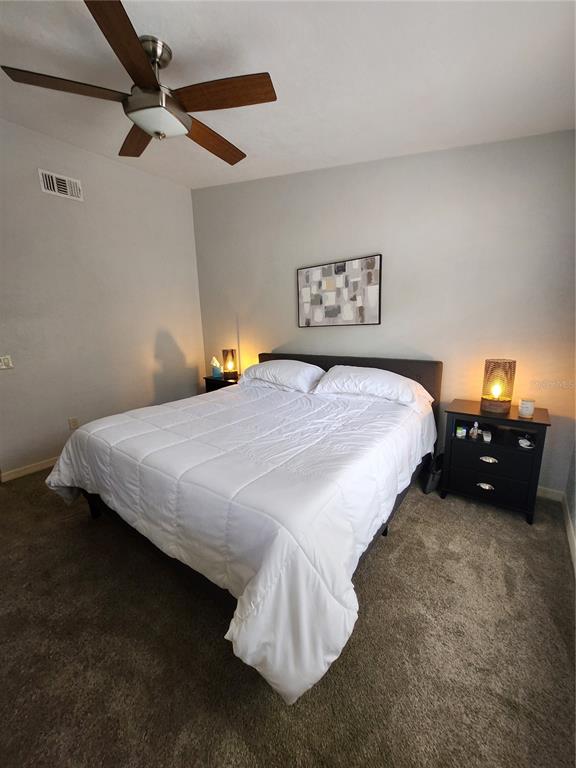 4801 Northwest 2nd Place Gainesville, FL 32607 - Photo 34 of 36 a bedroom with a bed and a chandelier