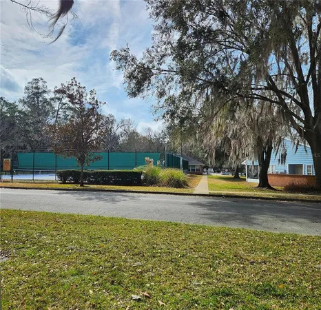 a view of swimming pool with trees and yard