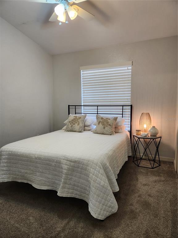 4801 Northwest 2nd Place Gainesville, FL 32607 - Photo 7 of 36 a bedroom with a bed a lamp and a chandelier