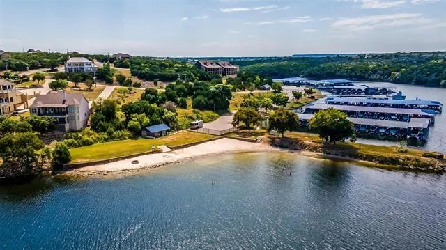 an aerial view of a house with a garden and lake view