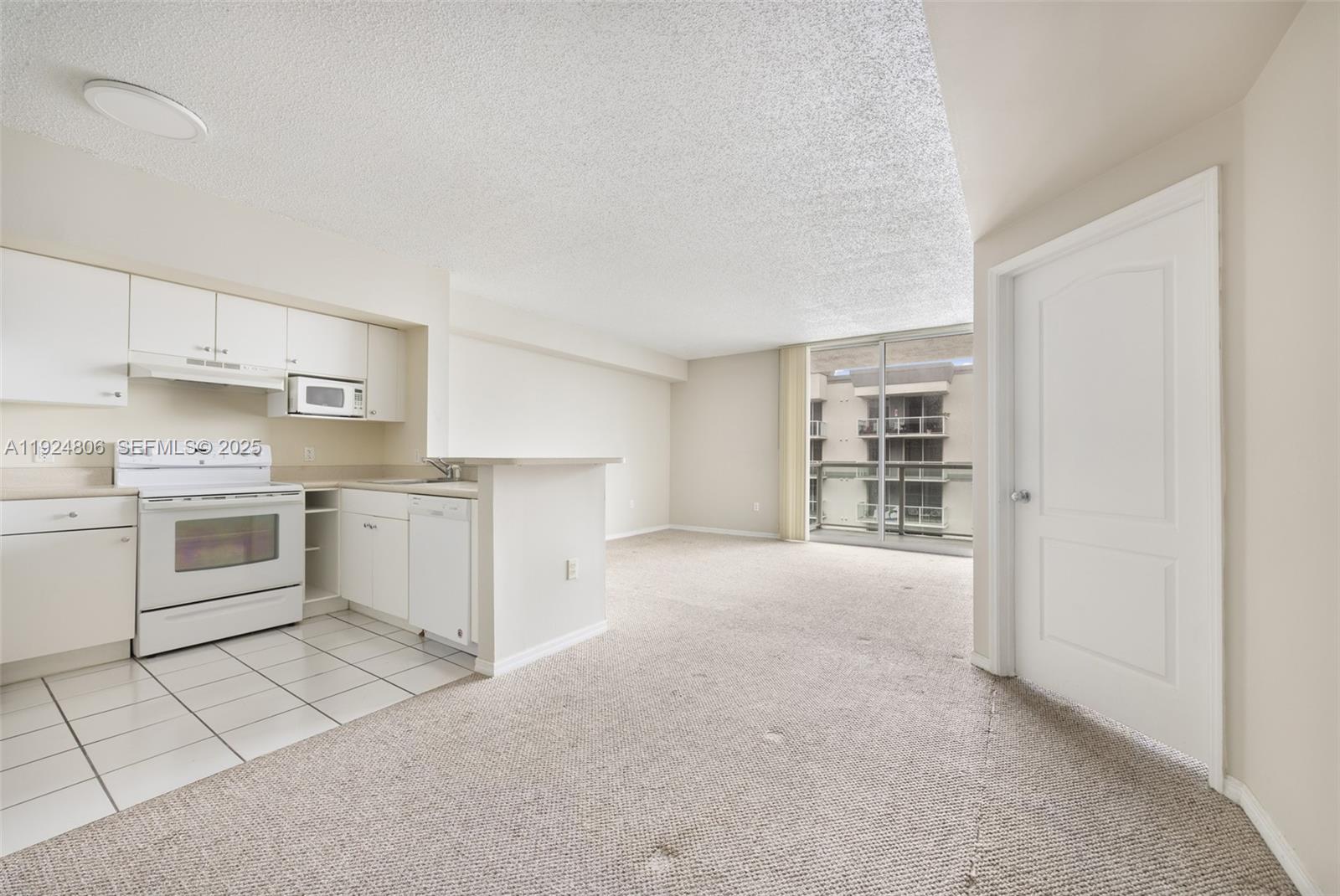 a kitchen with a stove top oven and cabinets