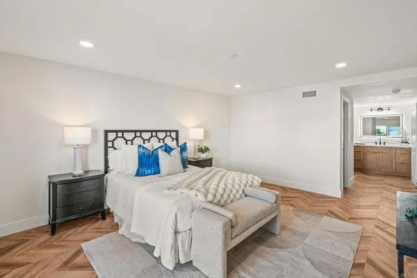a bedroom with a bed and a view of en suite bathroom