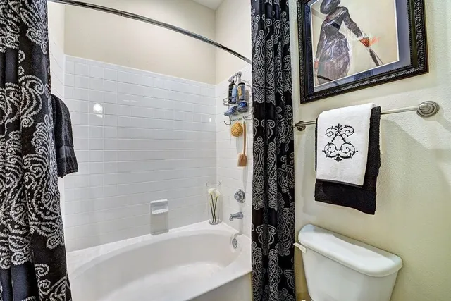 a bathroom with a toilet and a bathtub