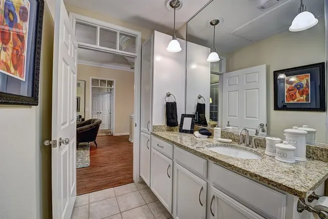 a spacious bathroom with a granite countertop sink a mirror and a shower