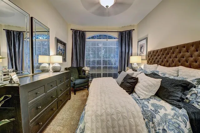 a bedroom with a large bed and a window