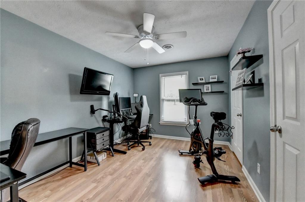 501 Wages Road Auburn, GA 30011 - Photo 21 of 50 a view of a workspace with furniture and a flat screen tv