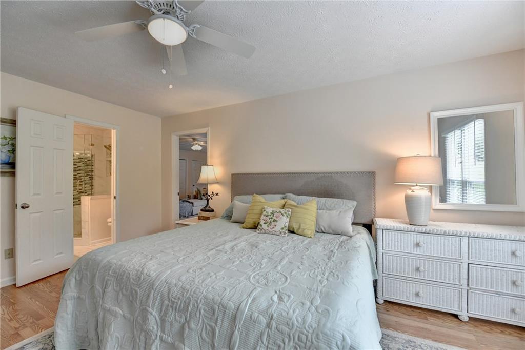 501 Wages Road Auburn, GA 30011 - Photo 29 of 50 a bedroom with a large bed and a chandelier