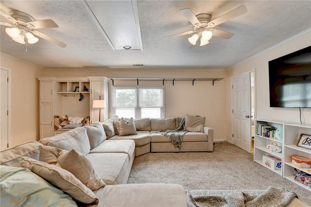 501 Wages Road Auburn, GA 30011 - Photo 37 of 50 a living room with furniture ceiling fan and a flat screen tv