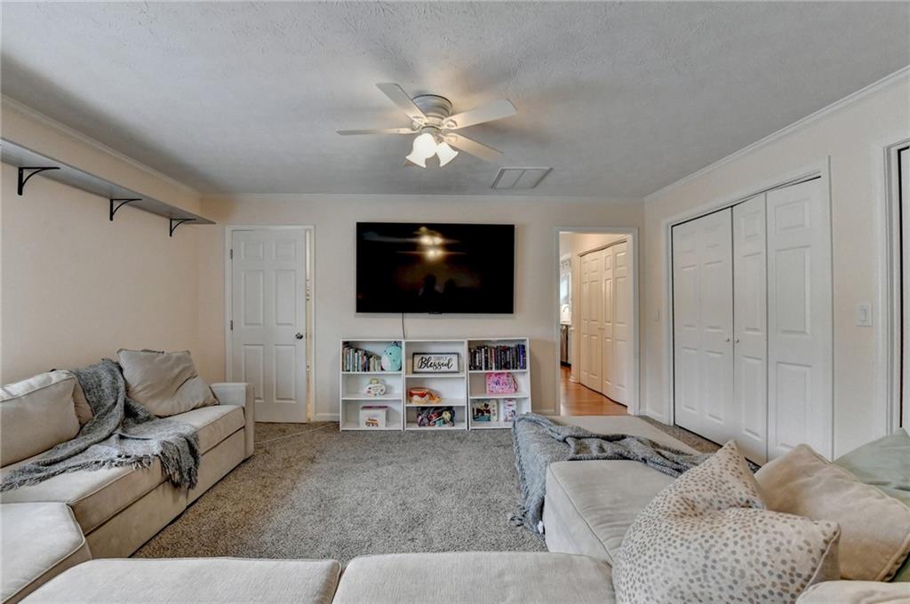 501 Wages Road Auburn, GA 30011 - Photo 39 of 50 a living room with furniture and a flat screen tv