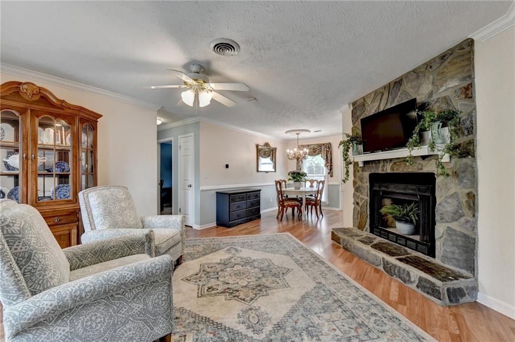 501 Wages Road Auburn, GA 30011 - Photo 6 of 50 a living room with furniture a flat screen tv and a fireplace
