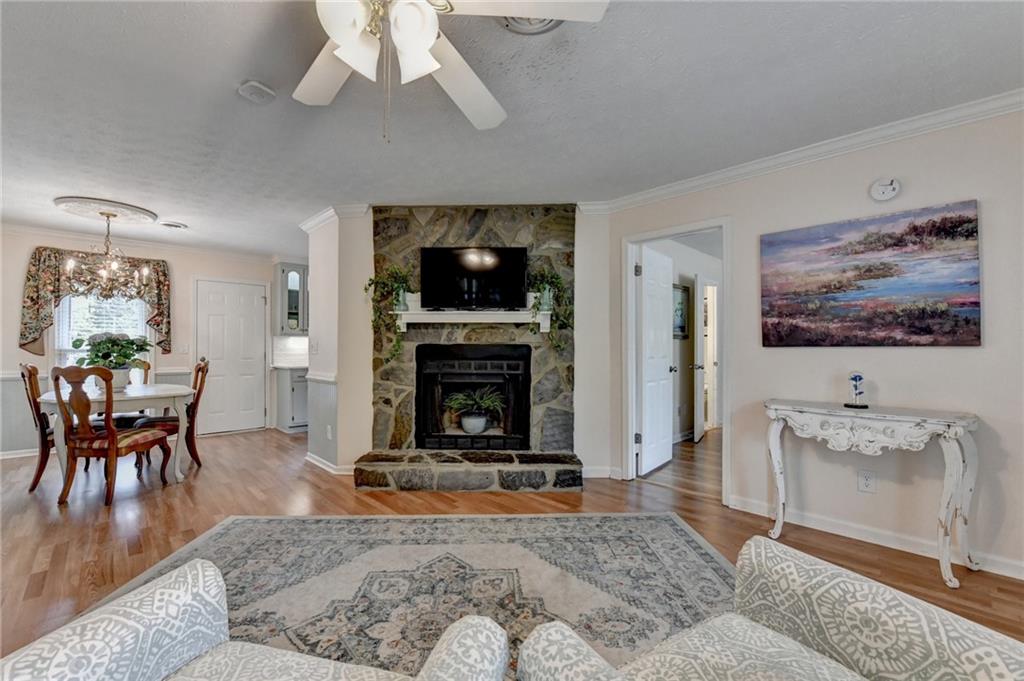 501 Wages Road Auburn, GA 30011 - Photo 7 of 50 a living room with furniture a fireplace and a flat screen tv