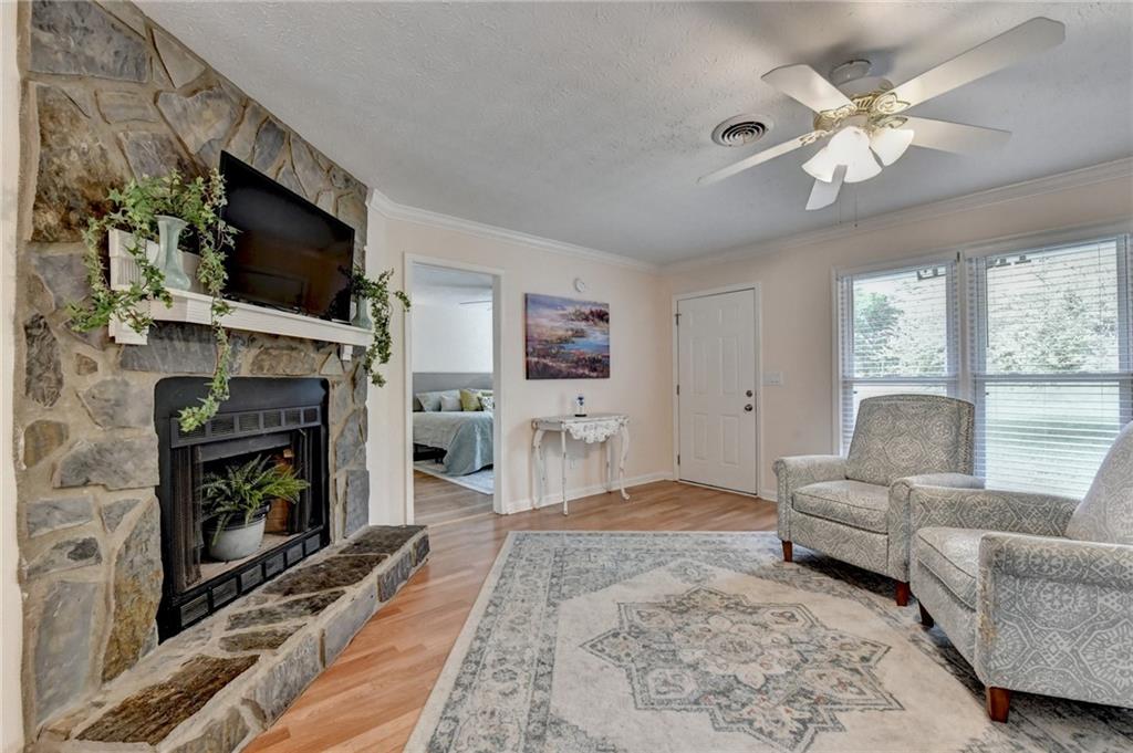 501 Wages Road Auburn, GA 30011 - Photo 9 of 50 a living room with furniture a flat screen tv and a fireplace
