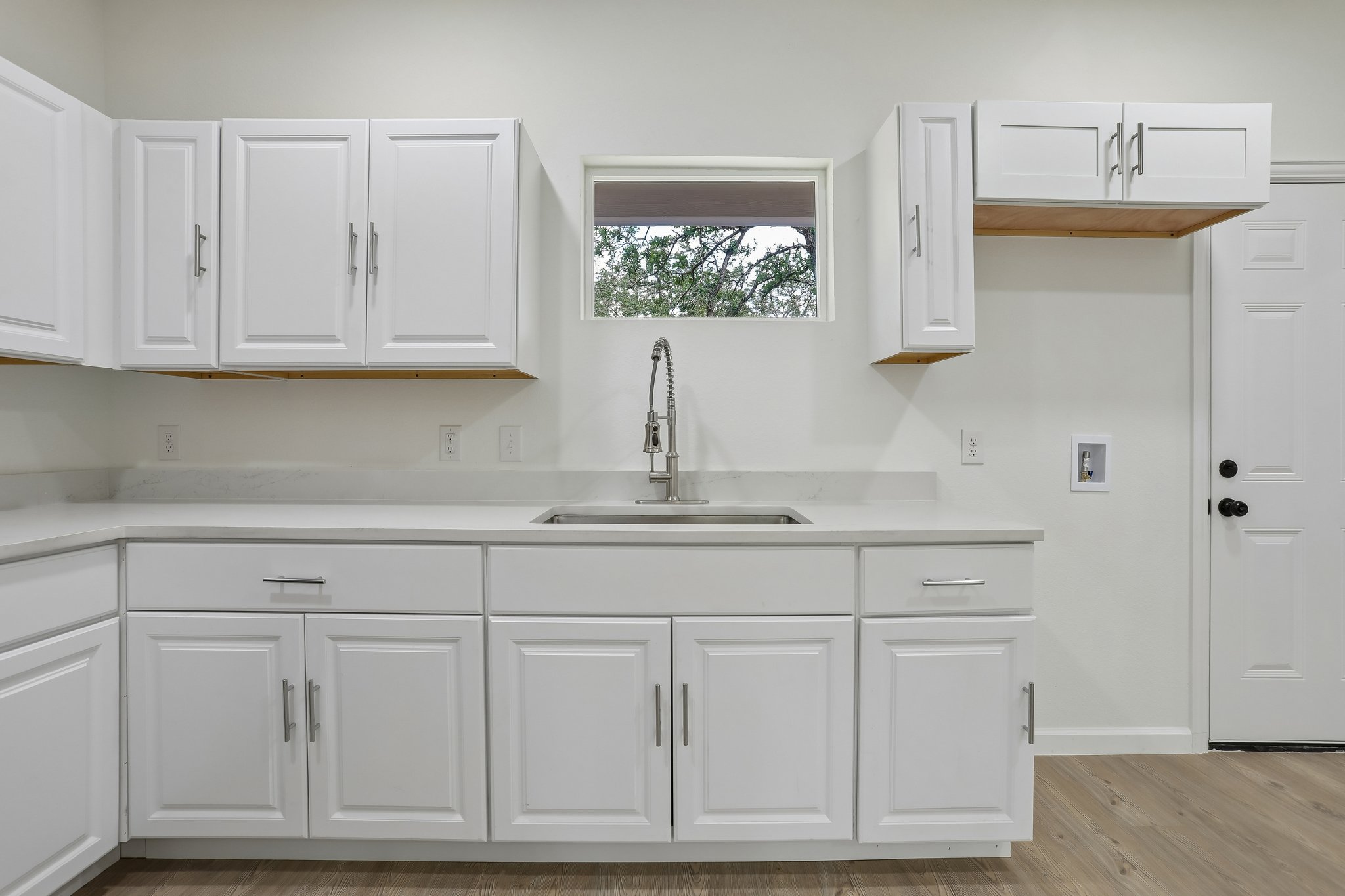 210 Flint Ridge Street Bastrop, TX 78602 - Photo 12 of 40 a kitchen with white cabinets and a sink