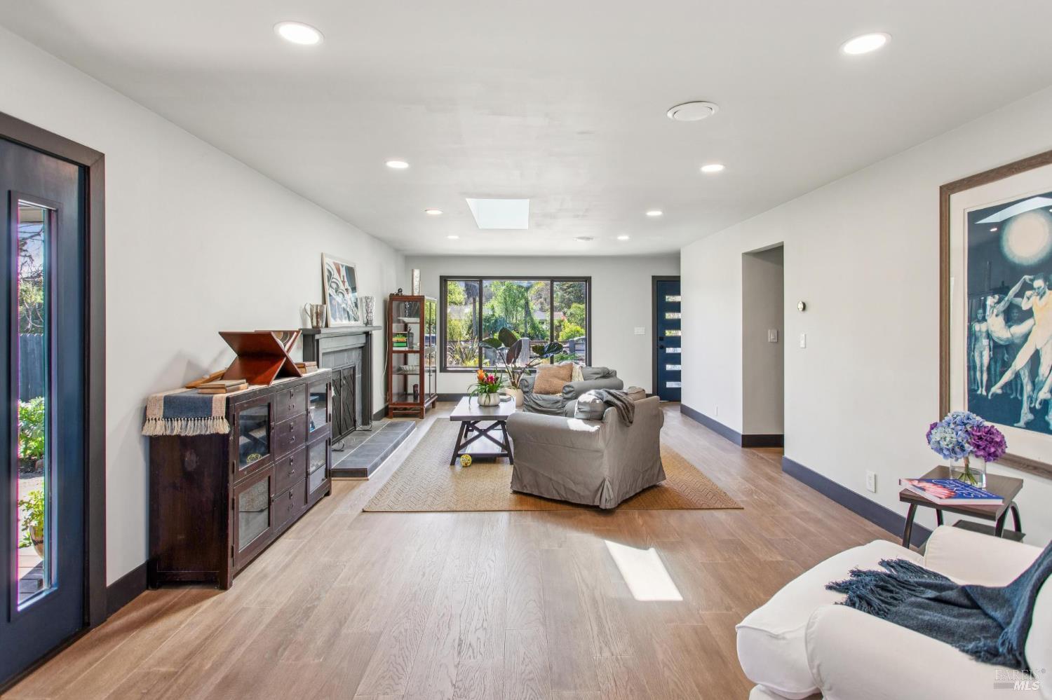 2100 Center Road Novato, CA 94947 - Photo 22 of 41 This living room has a fireplace and skylight. You could also use some of the space as a dining area.