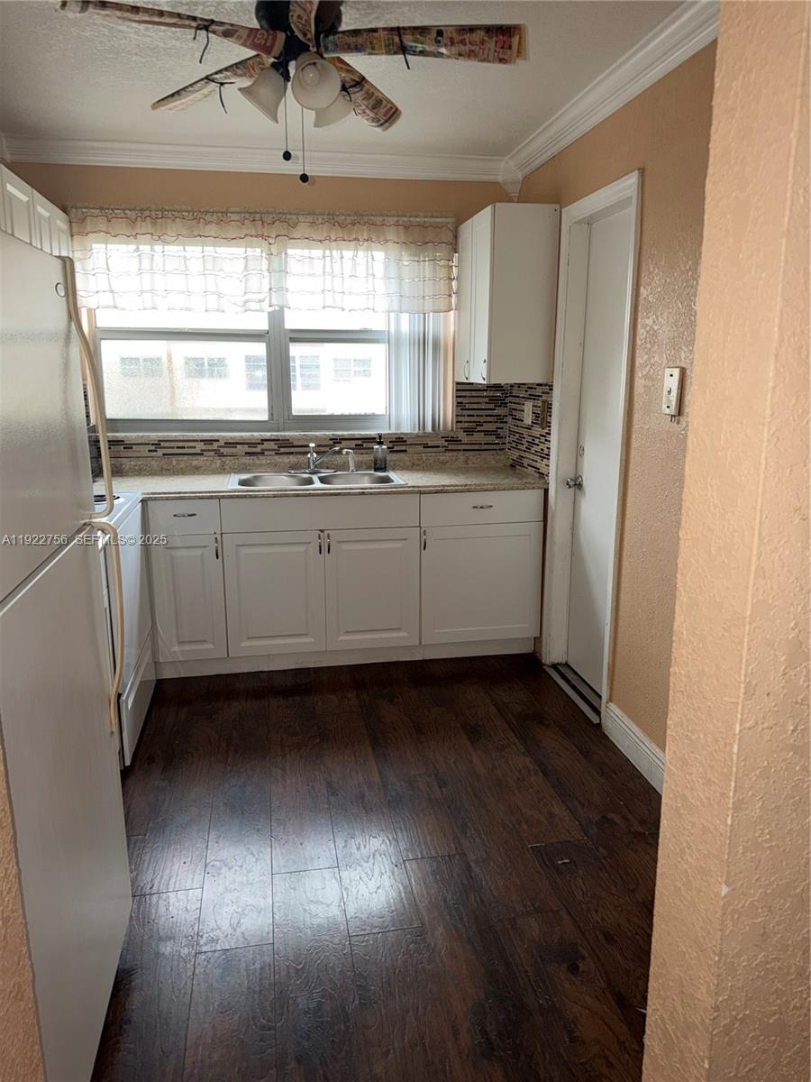 4042 Northwest 19th Street, Unit 305 Lauderhill, FL 33313 - Photo 2 of 8 a kitchen with granite countertop white cabinets and white appliances