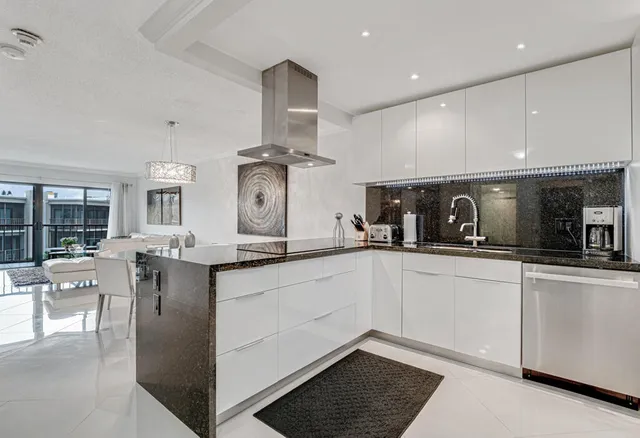 a kitchen with stainless steel appliances granite countertop a sink and cabinets