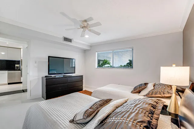 a kitchen with granite countertop a sink stainless steel appliances and window