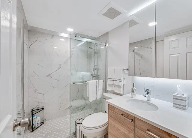 an aerial view of a house with a yard and lake view