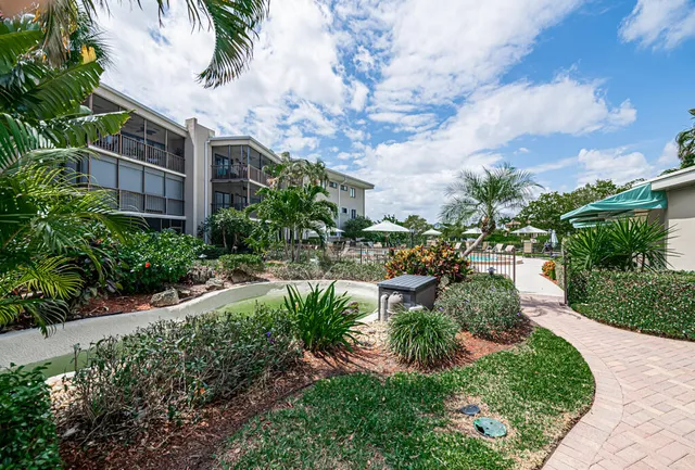 a view of a chair and table on the garden