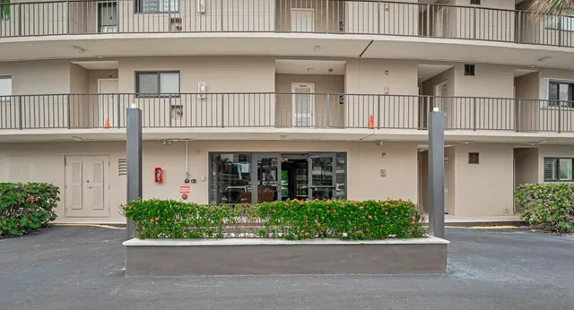 an aerial view of a house a yard and a fountain