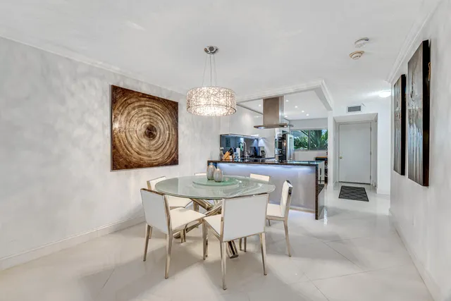 a view of a dining room with furniture wooden floor and a chandelier