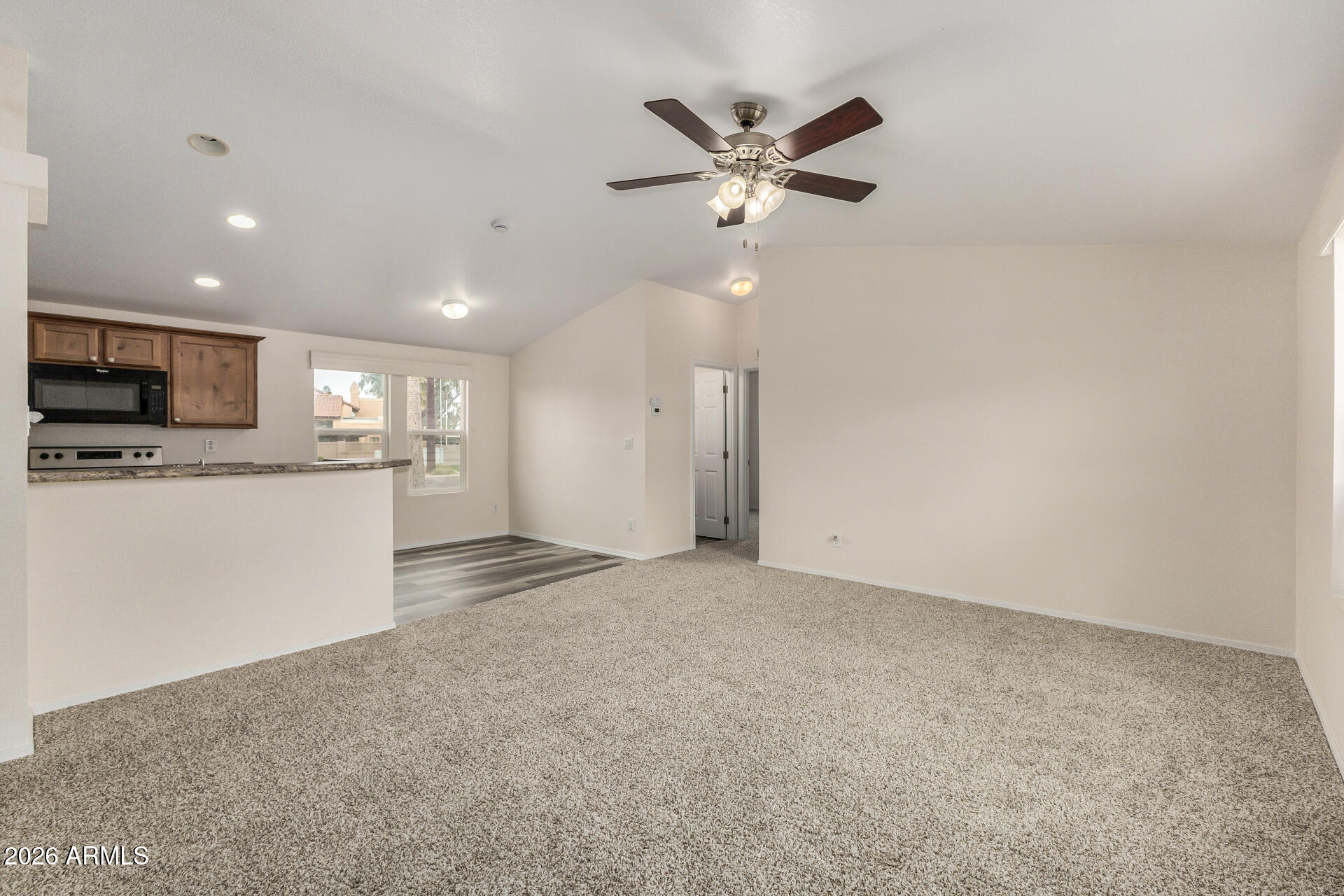 555 West Warner Road, Unit 55 Chandler, AZ 85225 - Photo 11 of 26 a view of a kitchen with a sink a ceiling fan and refrigerator