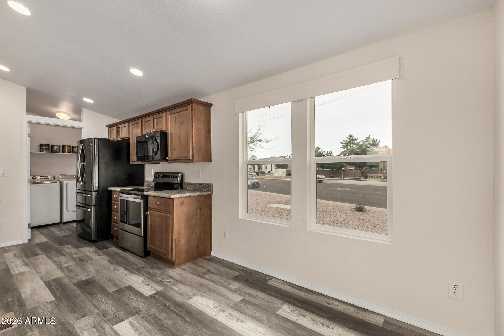 555 West Warner Road, Unit 55 Chandler, AZ 85225 - Photo 13 of 26 a kitchen with stainless steel appliances granite countertop a refrigerator and a stove top oven