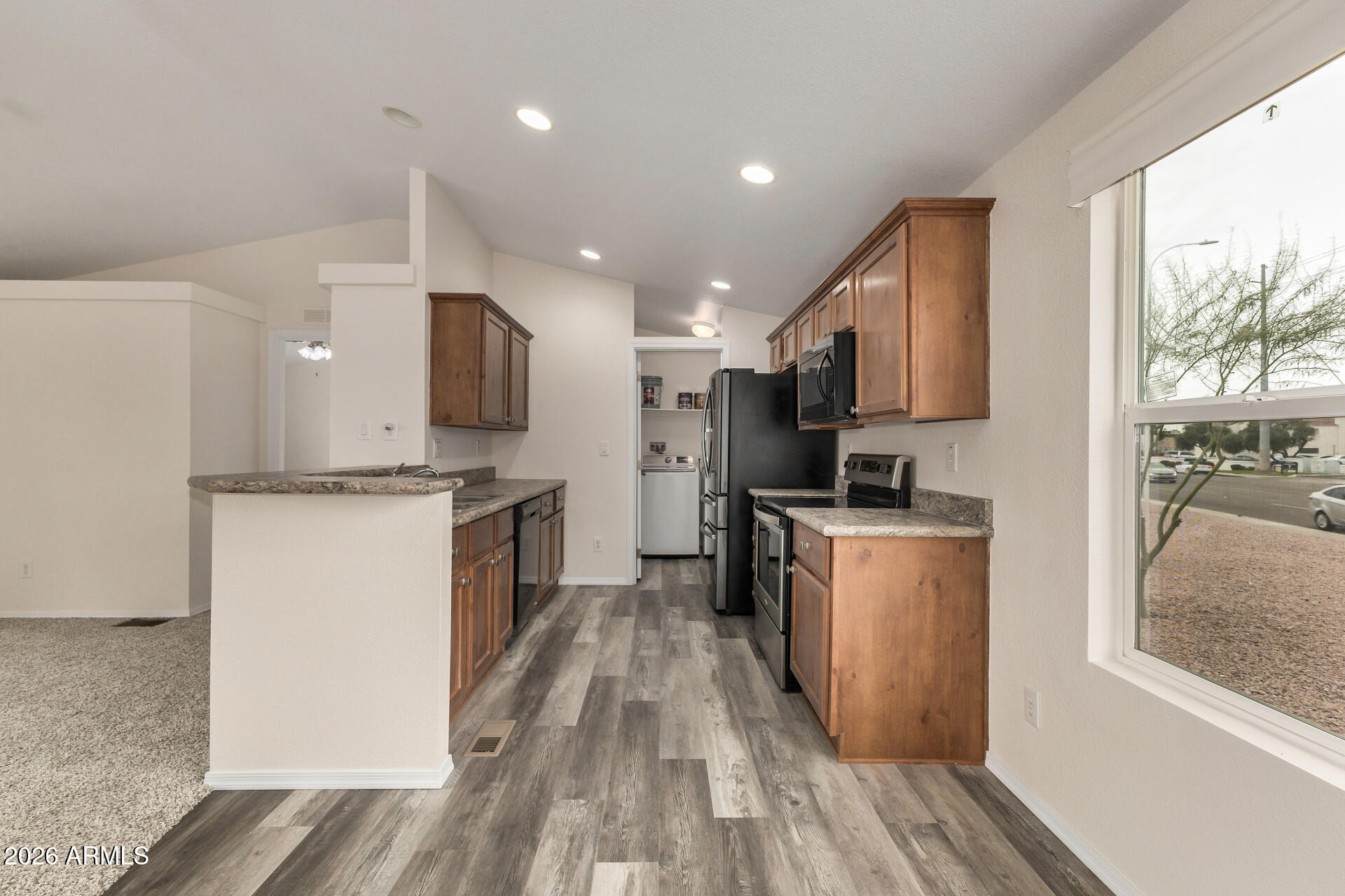 555 West Warner Road, Unit 55 Chandler, AZ 85225 - Photo 14 of 26 a kitchen with a refrigerator a stove top oven a sink dishwasher and wooden floor