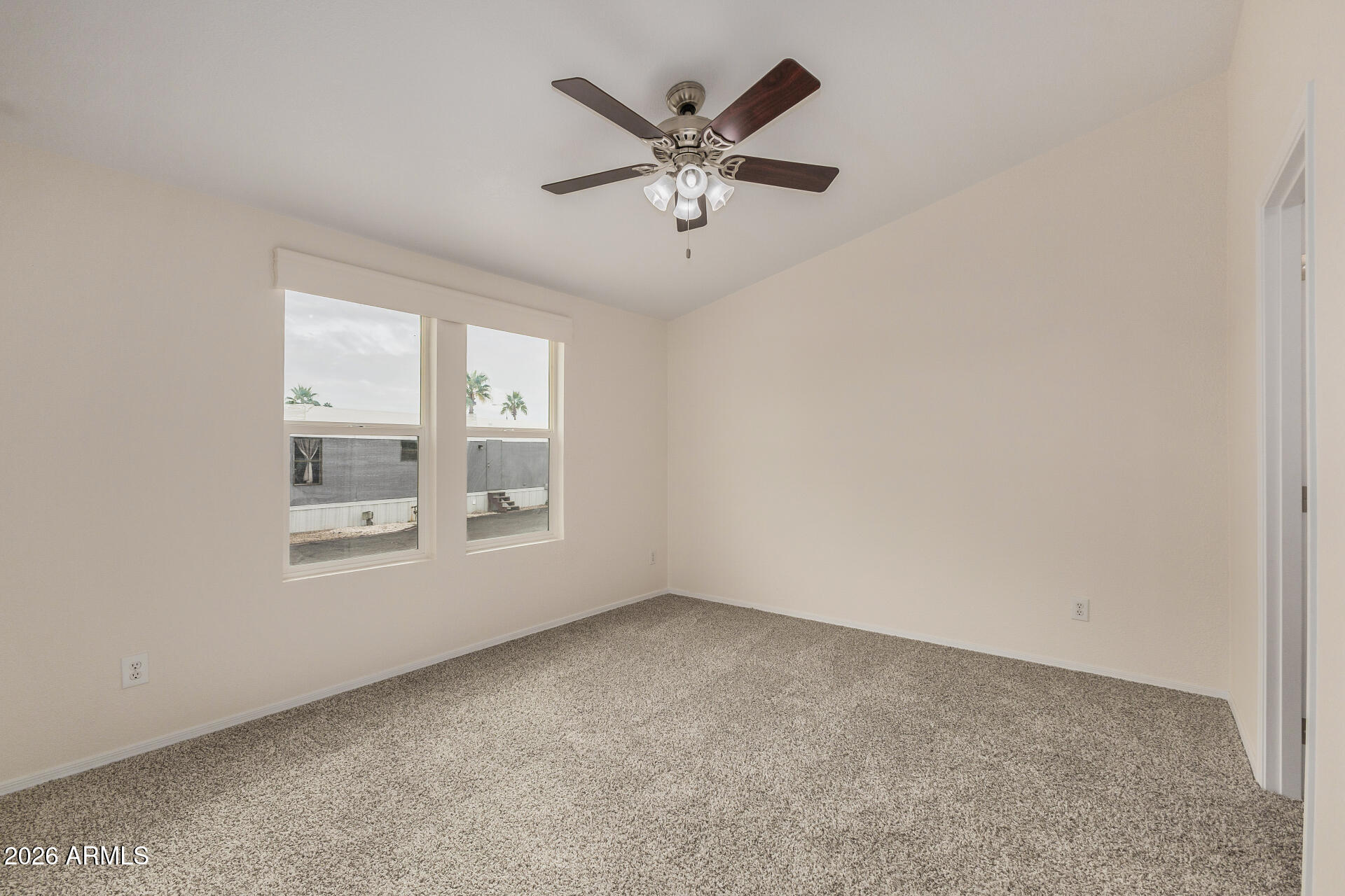 555 West Warner Road, Unit 55 Chandler, AZ 85225 - Photo 17 of 26 an empty room with ceiling fan and windows