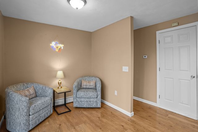 a living room with furniture and a lamp