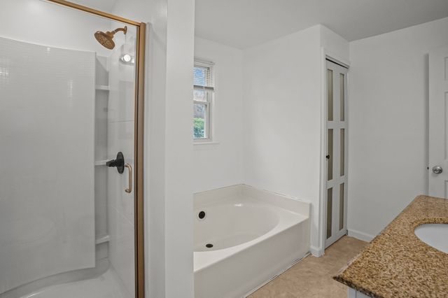 a bathroom with a bathtub and a shower