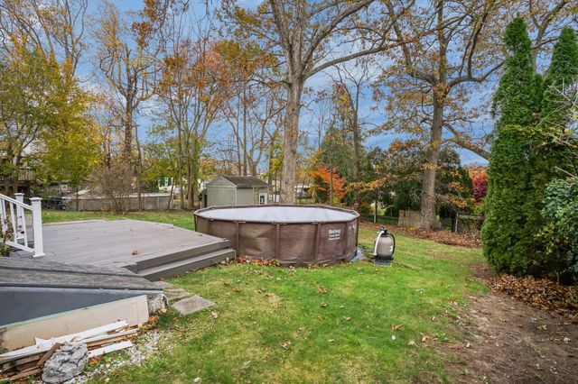 a view of a backyard with swimming pool