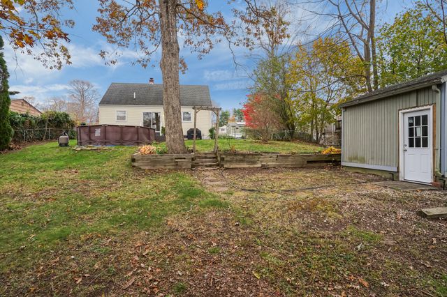 a view of backyard of house with green space