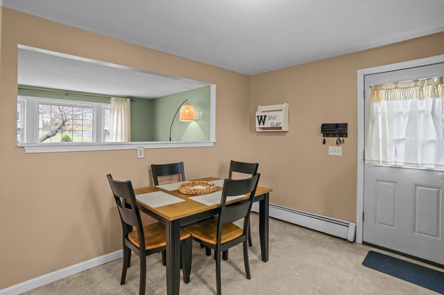 a view of a dining room with furniture and window