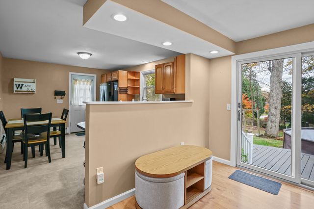 a living room with furniture a piano and a window