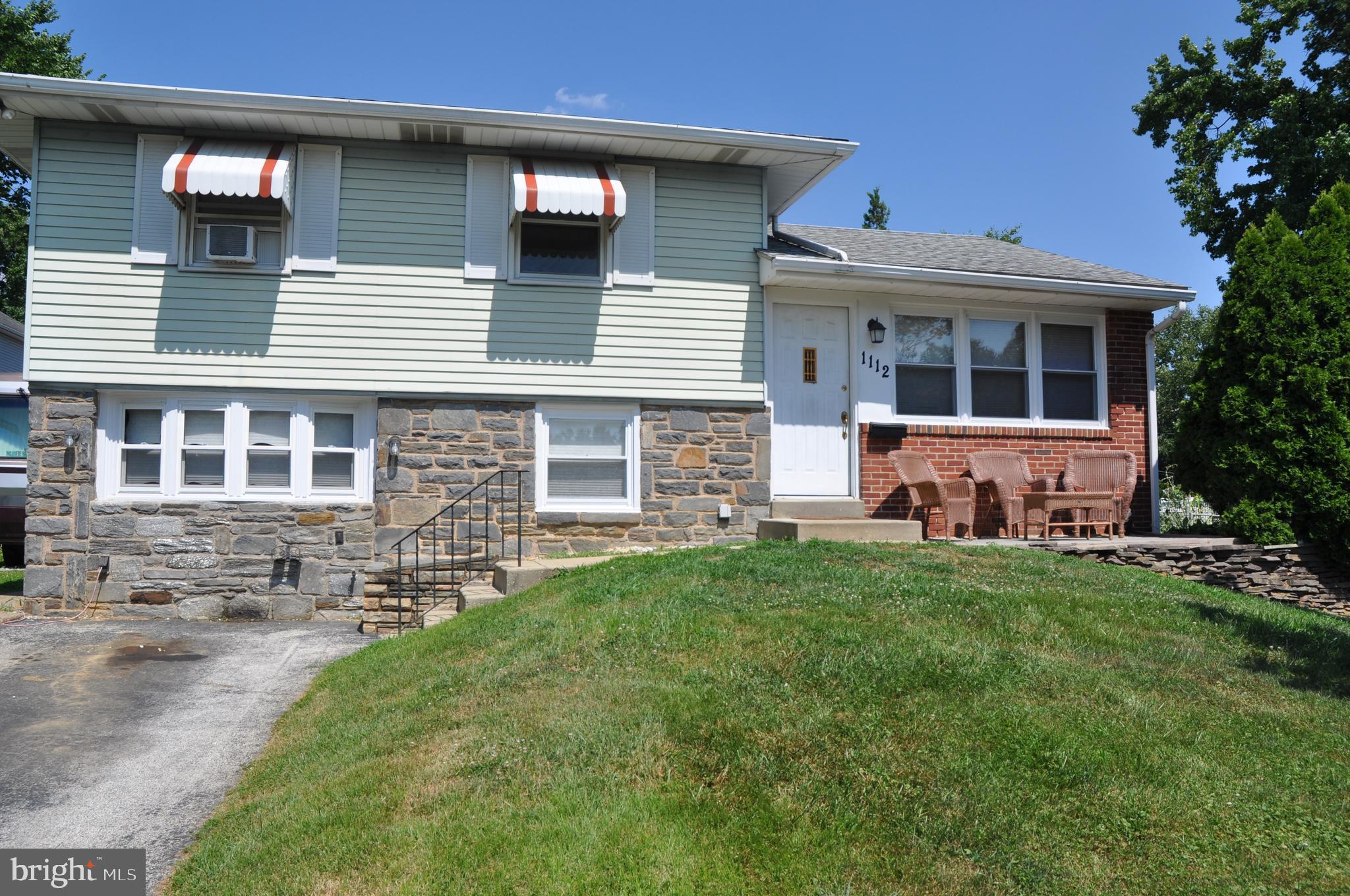 1112 Wynnbrook Road Secane, PA 19018 - Photo 1 of 14 a front view of house with yard and green space