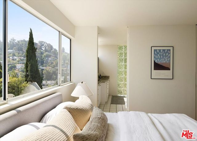 a bedroom with a large bed and a large window