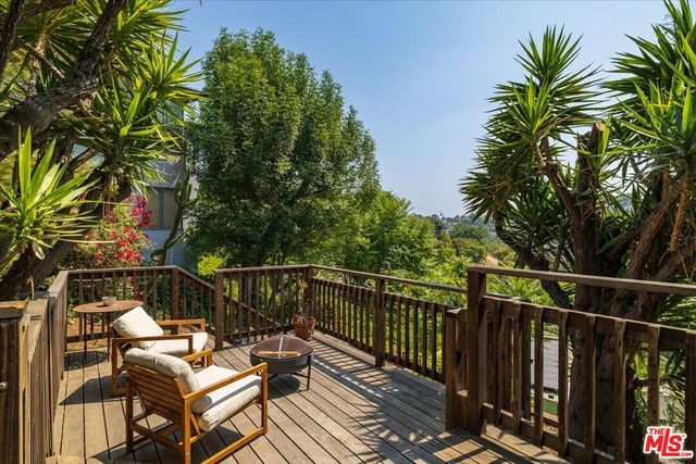 a view of a roof deck with wooden floor and fence