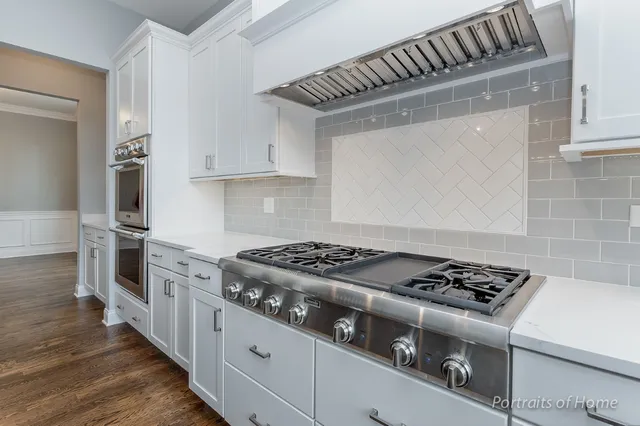 a kitchen with granite countertop stainless steel appliances and wooden cabinets