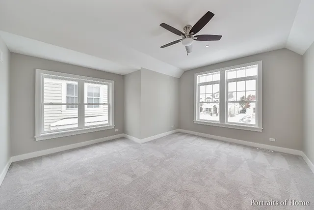 a view of a livingroom with a ceiling fan and window