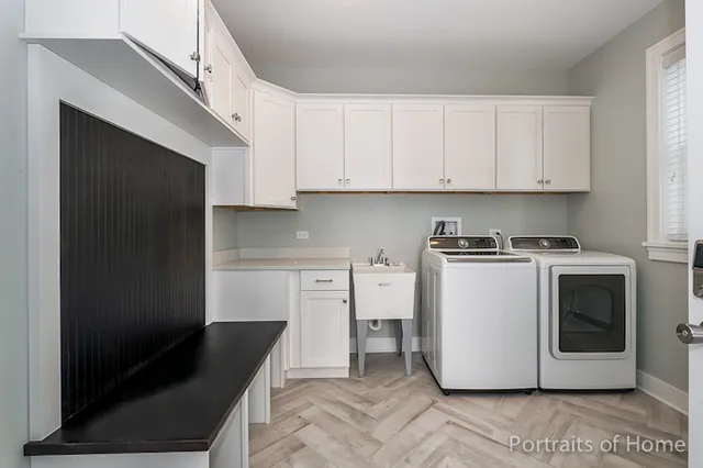 a kitchen with a refrigerator stove and white cabinets