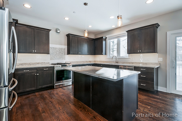 6340 Tennessee Avenue Willowbrook, IL 60527 - Photo 7 of 23 a kitchen with stainless steel appliances granite countertop a sink stove and refrigerator