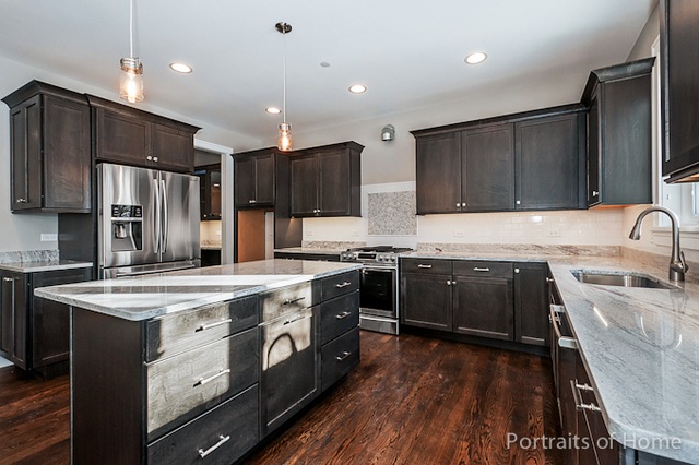 6340 Tennessee Avenue Willowbrook, IL 60527 - Photo 8 of 23 a kitchen with stainless steel appliances kitchen island granite countertop a stove a sink and a refrigerator