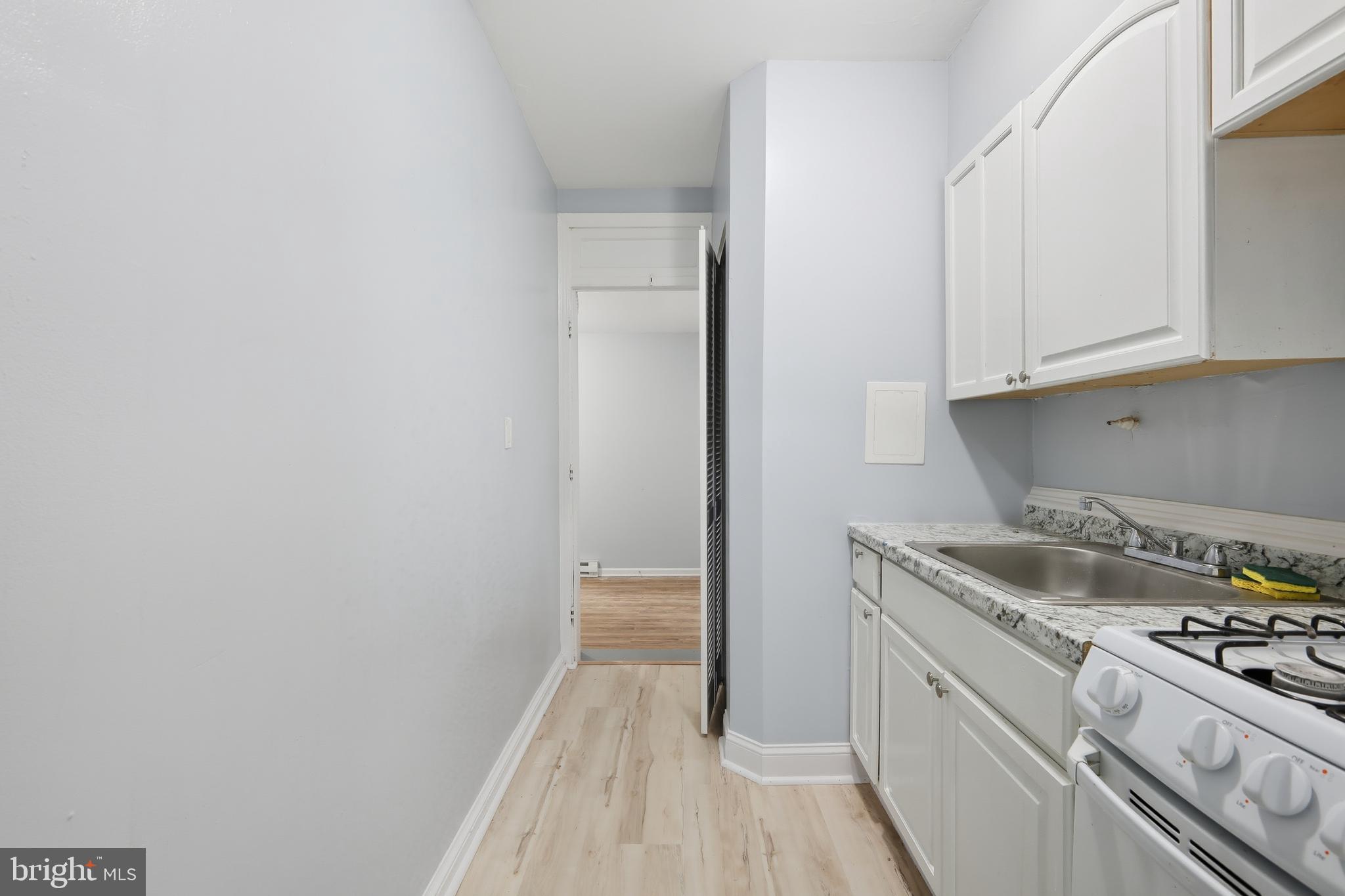 3919 R Street Southeast Washington, DC 20020 - Photo 13 of 41 a kitchen with a sink and cabinets
