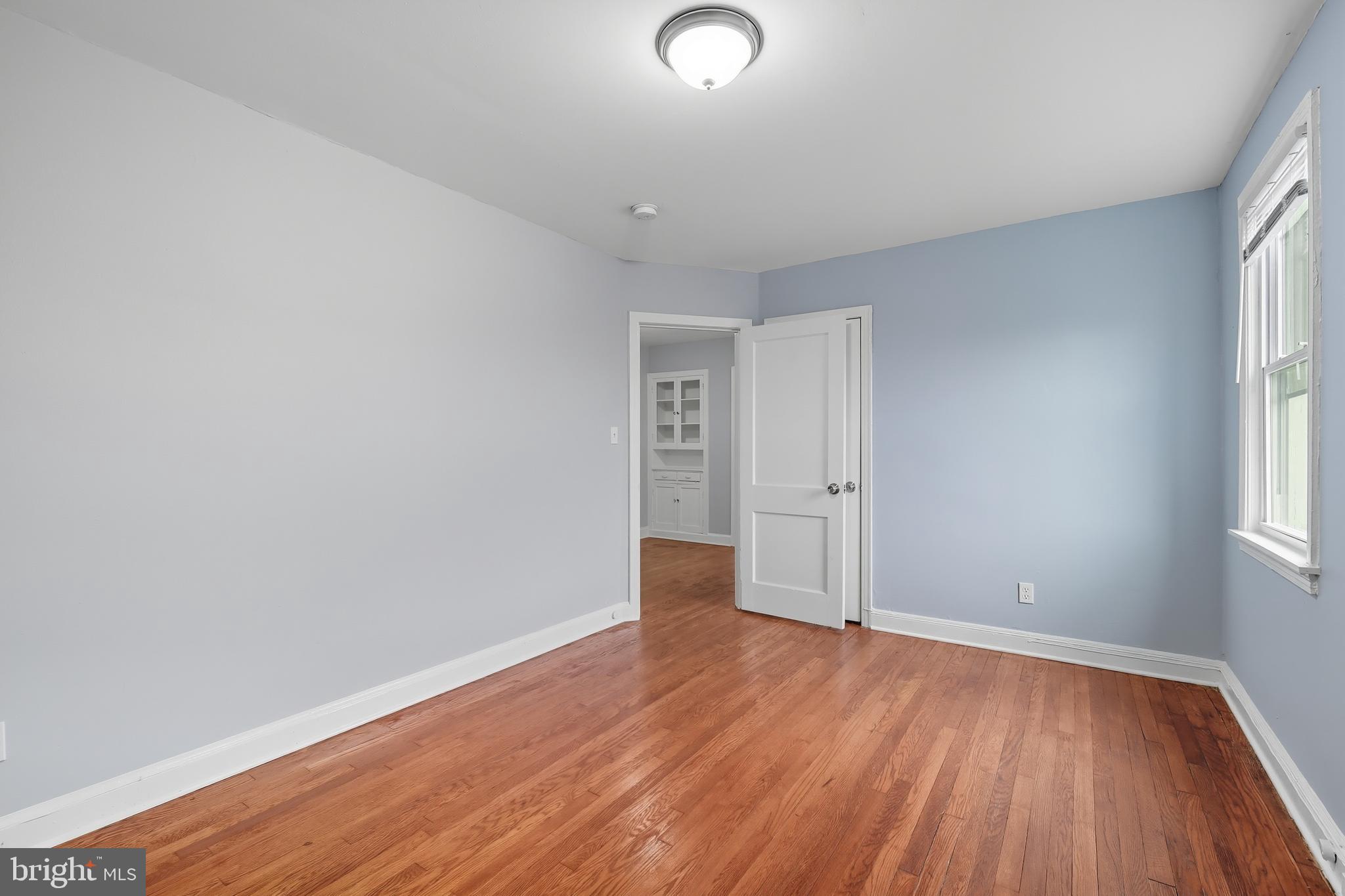 3919 R Street Southeast Washington, DC 20020 - Photo 33 of 41 an empty room with wooden floor and windows