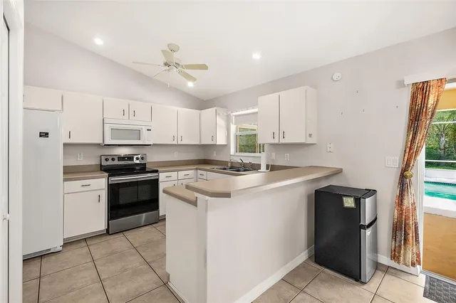 a kitchen with a stove sink and a refrigerator