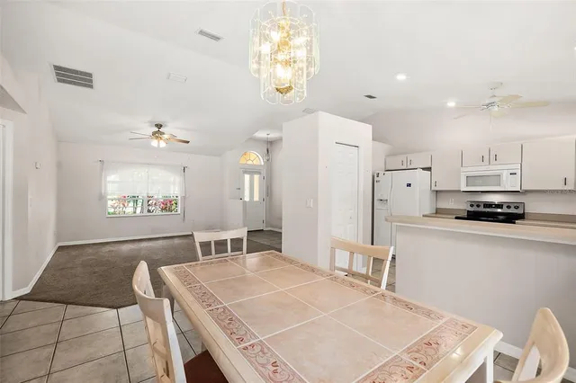 a open kitchen with stainless steel appliances granite countertop a sink refrigerator and cabinets